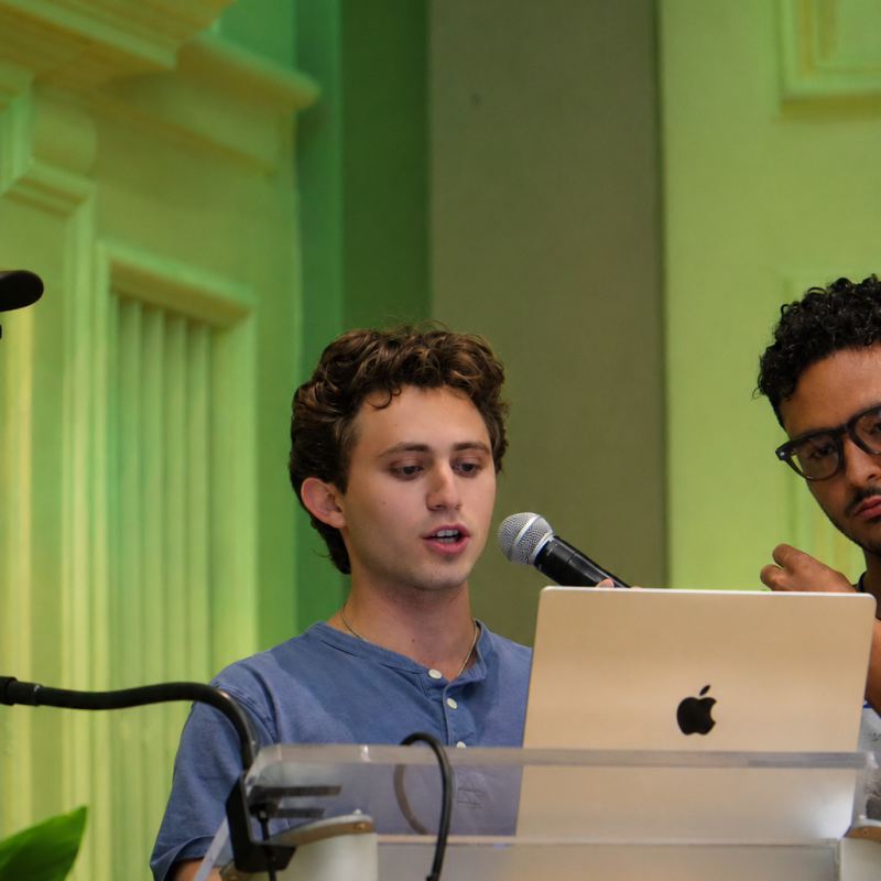Brandon Shore presenting at a lectern